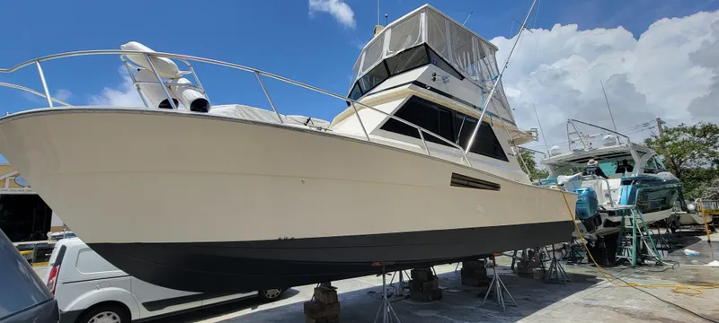 Slide: The Image of 1990 Viking 35 boat on dry dock under a clear blue sky. - 1