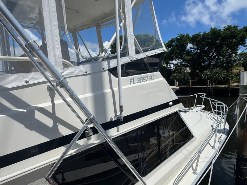 Slide: The Image of 1990 Viking 35 boat docked, featuring sleek design and registration number FL 3897 RJ. - 10