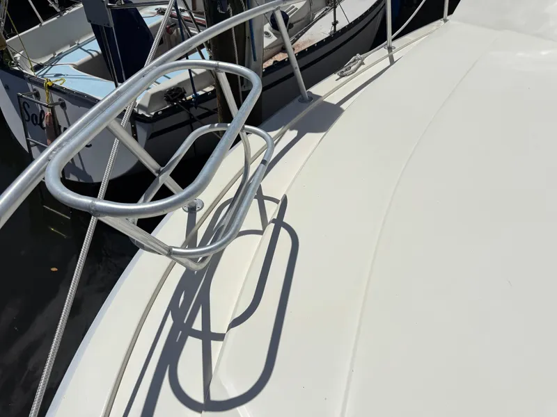 Slide: The Image of Bow railing of a 1990 Viking 35 boat, docked in a marina. - 11