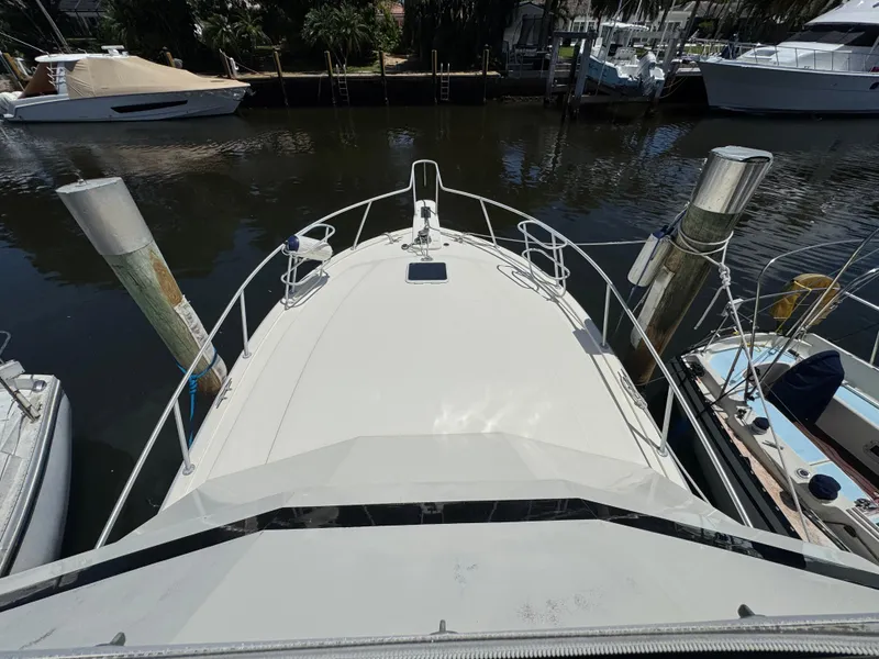 Slide: The Image of Bow view of a 1990 Viking 35 yacht docked at a marina. - 13