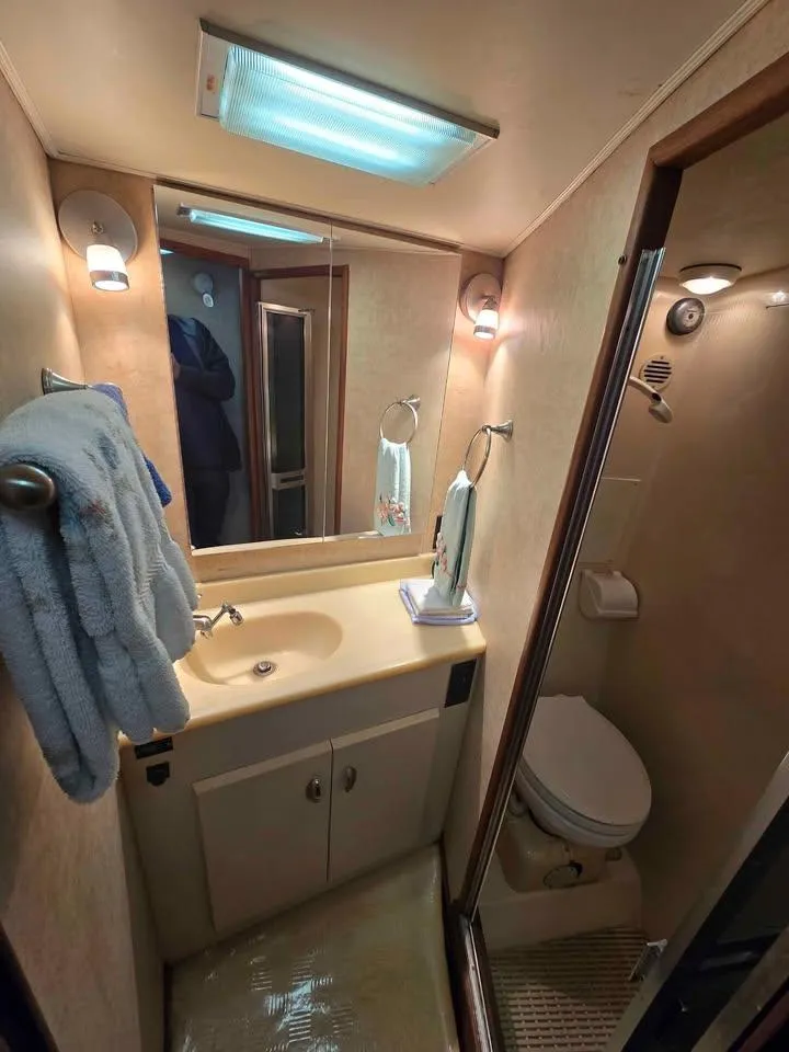 Slide: The Image of 1990 Viking 35 yacht bathroom with sink, mirror, and toilet. - 133
