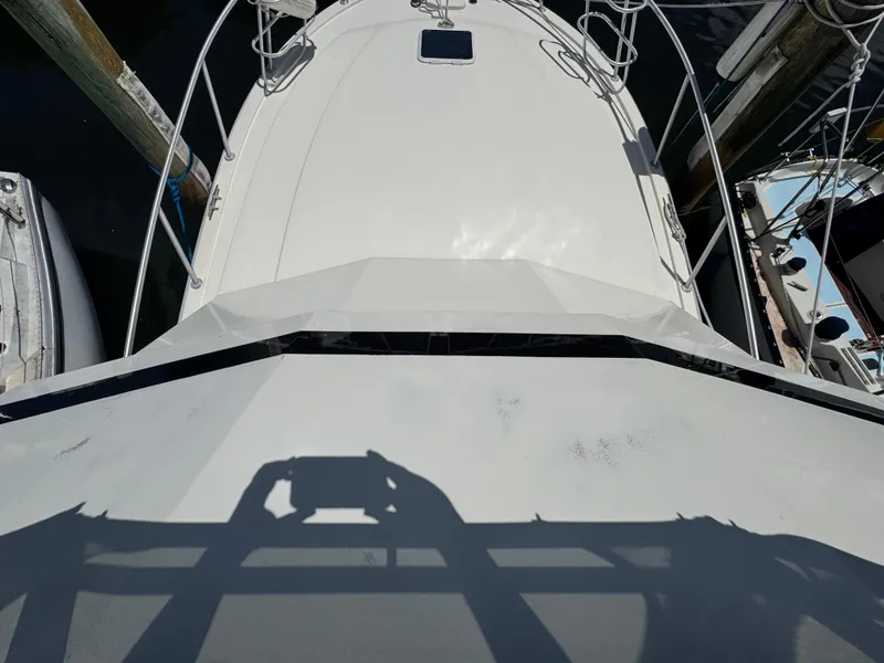 Slide: The Image of Overhead view of a 1990 Viking 35 boat docked at a marina. - 16