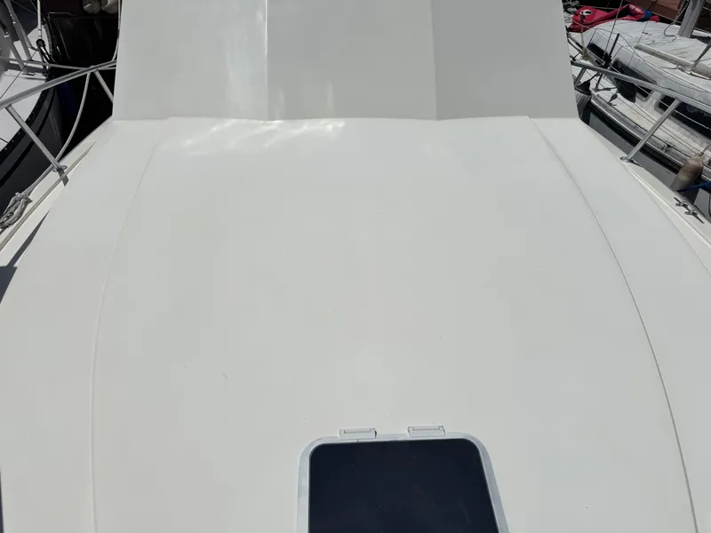 Slide: The Image of Deck of a 1990 Viking 35 boat, featuring a clean, white surface. - 18