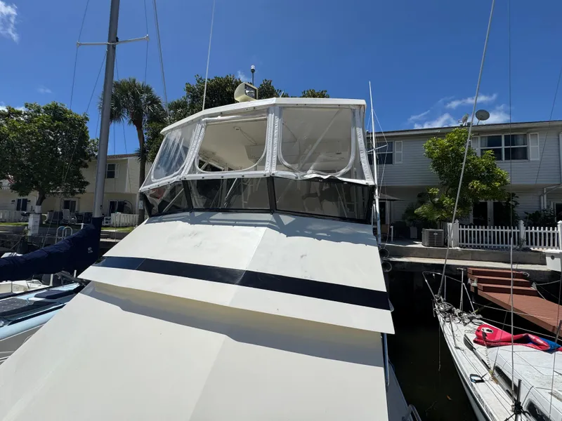 Slide: The Image of 1990 Viking 35 boat docked near residential area under clear blue sky. - 20