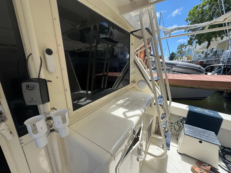 Slide: The Image of 1990 Viking 35 boat deck with fishing rod holders and docked view. - 27