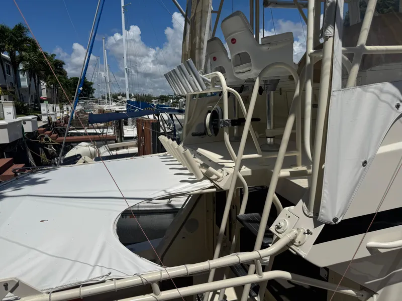 Slide: The Image of 1990 Viking 35 boat docked at marina, featuring helm chairs and rigging. - 29