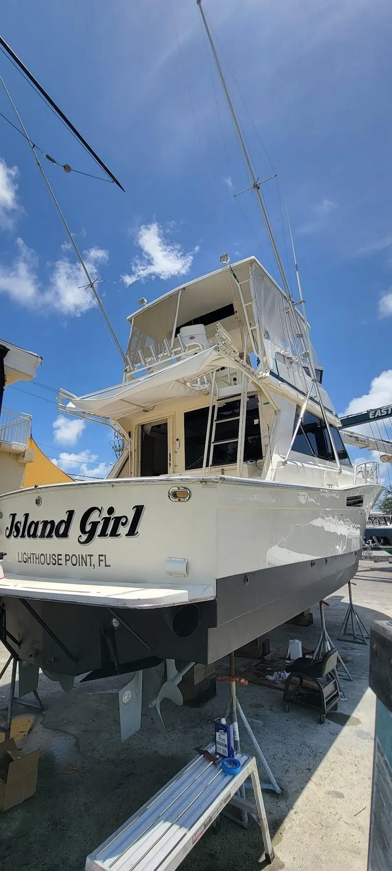 Slide: The Image of 1990 Viking 35 boat named "Island Girl" docked under a clear blue sky. - 3