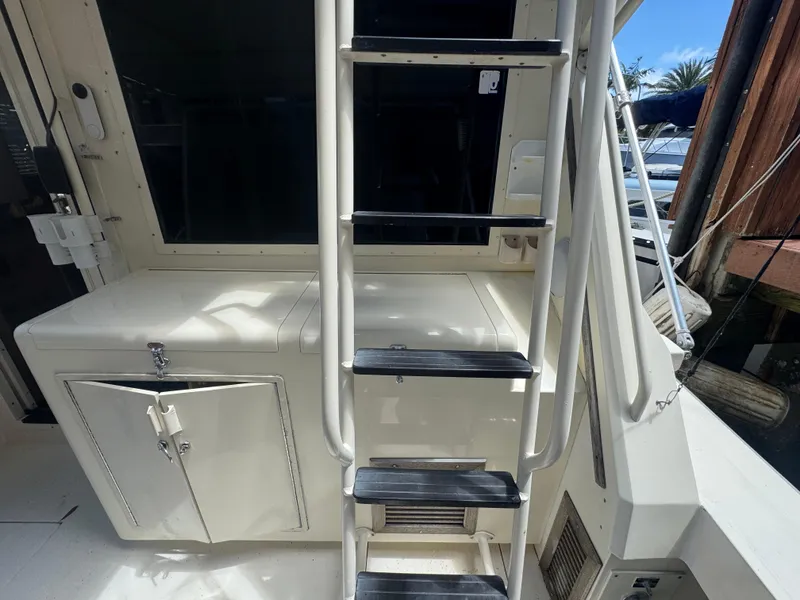 Slide: The Image of 1990 Viking 35 boat interior with ladder and storage cabinet. - 33