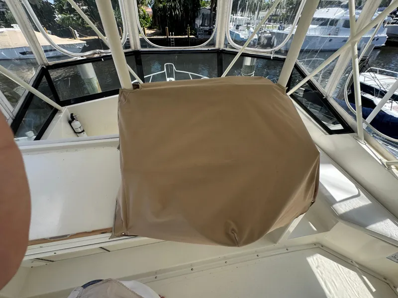 Slide: The Image of Covered helm station on a 1990 Viking 35 boat, docked in a marina. - 38