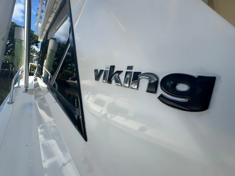Slide: The Image of 1990 Viking 35 boat with sleek design and reflective logo. - 4