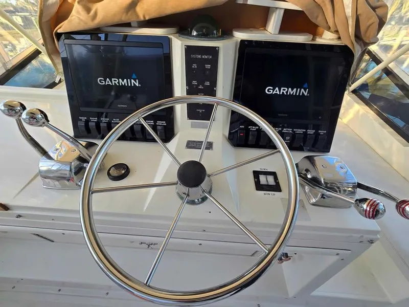 Slide: The Image of Helm of 1990 Viking 35 boat with Garmin navigation displays and steering wheel. - 40