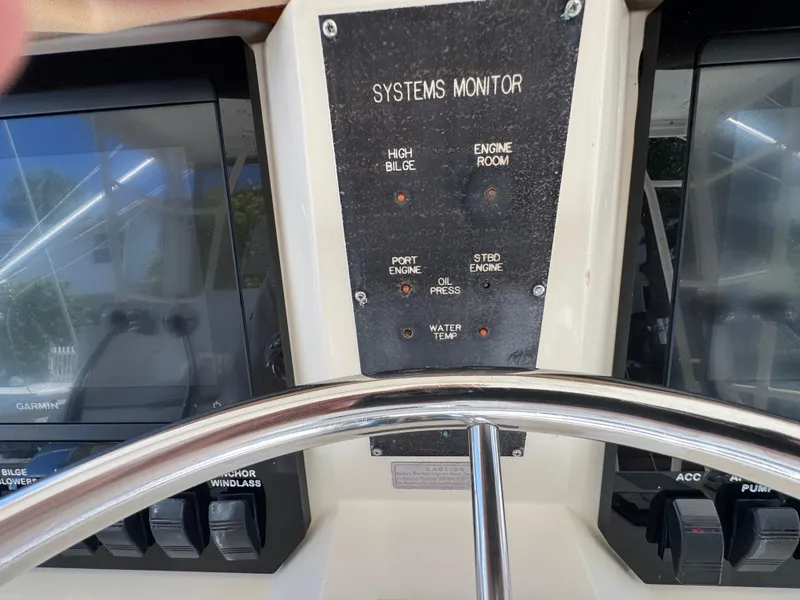 Slide: The Image of Control panel of a 1990 Viking 35 boat with systems monitor and steering wheel. - 41