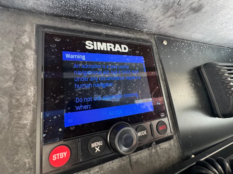 Slide: The Image of Simrad autopilot warning screen on a 1990 Viking 35 boat, cautioning against replacing human navigation. - 42