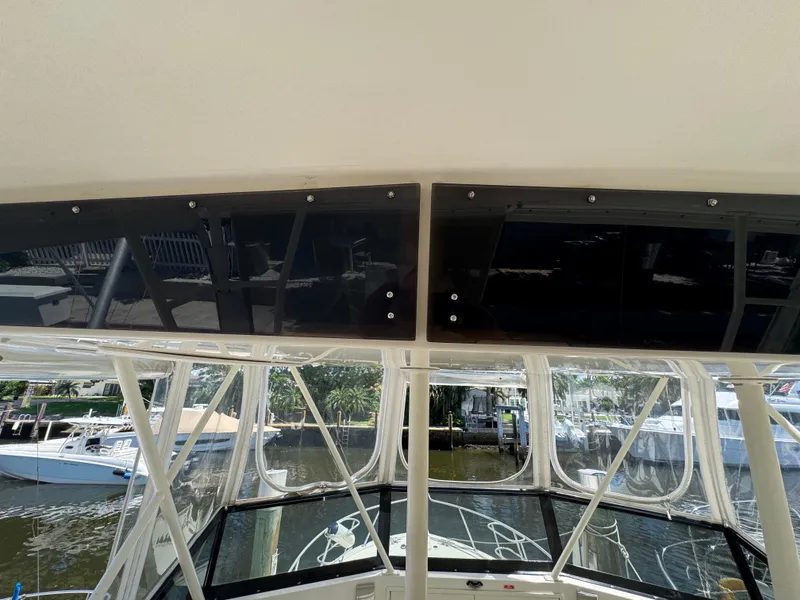 Slide: The Image of 1990 Viking 35 boat cockpit with clear windows and marina view. - 44
