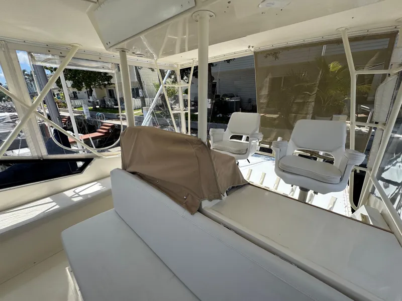 Slide: The Image of Interior of a 1990 Viking 35 boat with white seating and clear windows. - 46