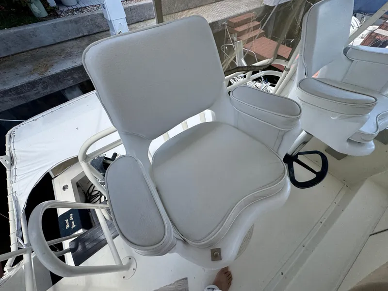 Slide: The Image of White captain's chair on a 1990 Viking 35 boat deck. - 48