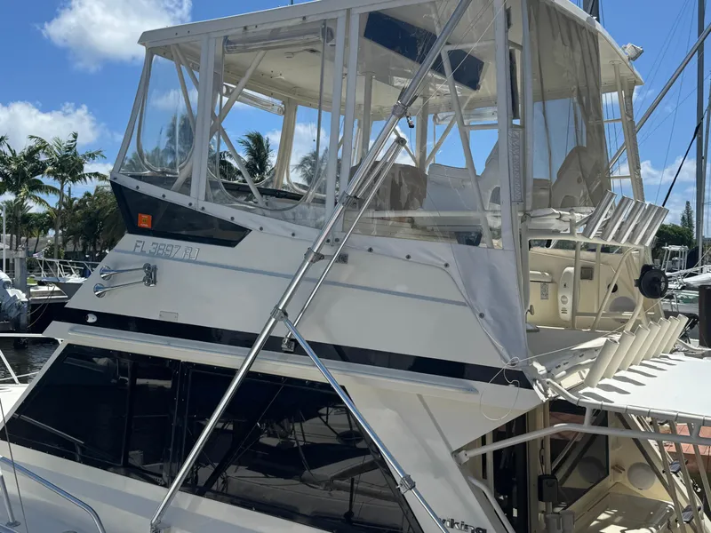 Slide: The Image of 1990 Viking 35 yacht docked, featuring a spacious upper deck and clear skies. - 6