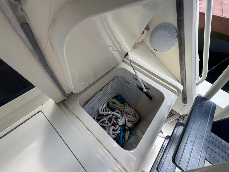 Slide: The Image of Storage compartment on a 1990 Viking 35 boat, containing ropes and equipment. - 78