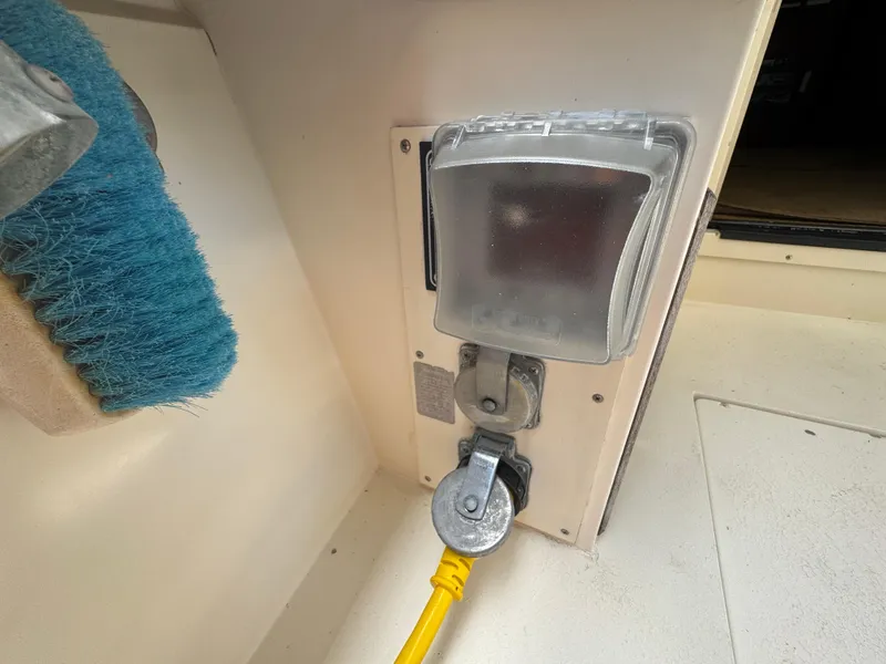 Slide: The Image of Electrical outlet with yellow cable on a 1990 Viking 35 boat. - 79