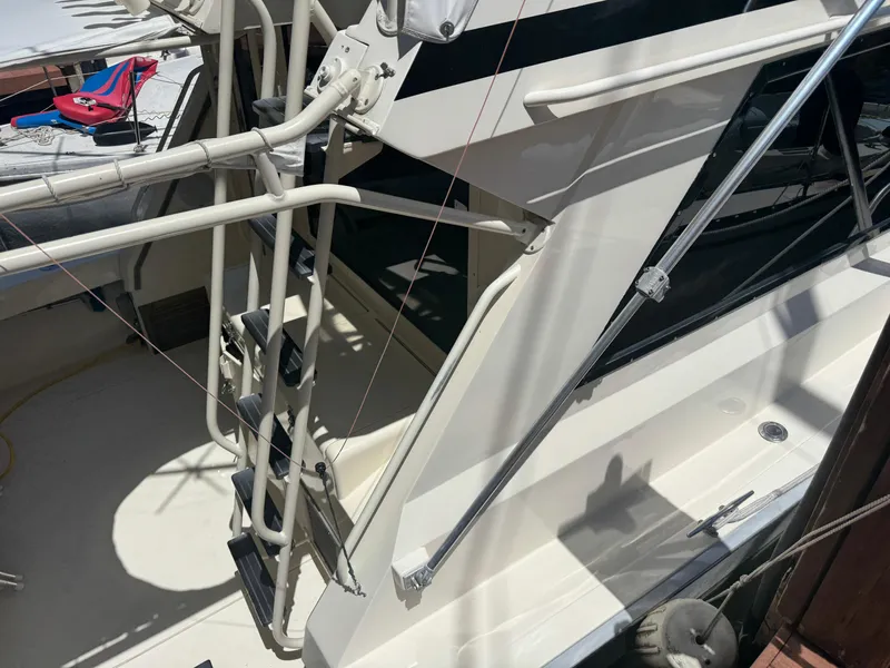 Slide: The Image of 1990 Viking 35 boat with ladder and deck, featuring sleek design and sturdy construction. - 8