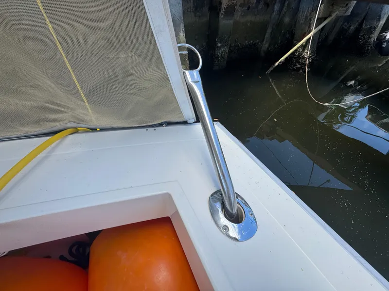 Slide: The Image of 1990 Viking 35 boat deck with orange buoys and metal railing by the water. - 80