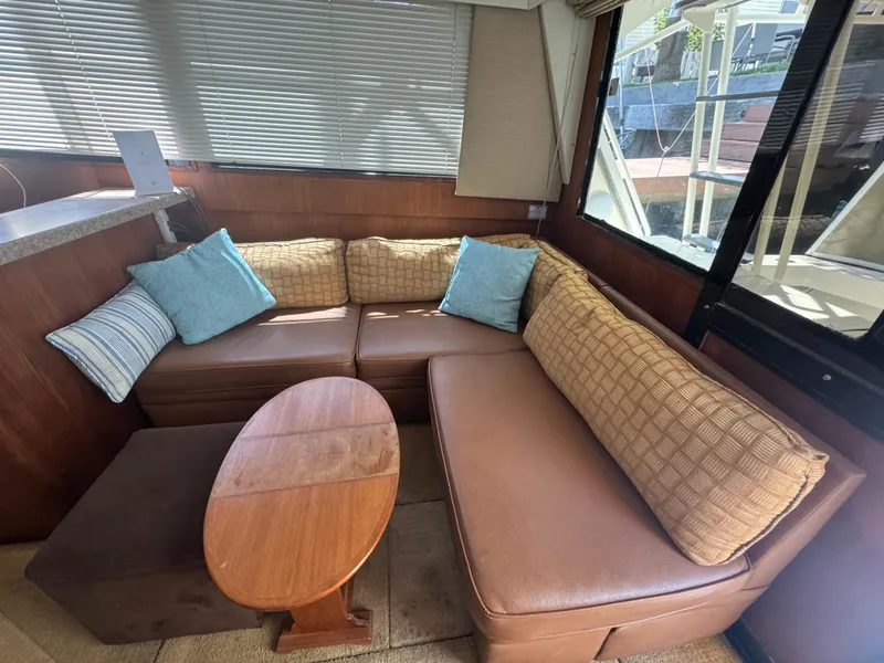 Slide: The Image of Cozy interior of 1990 Viking 35 yacht with brown seating and decorative cushions. - 89