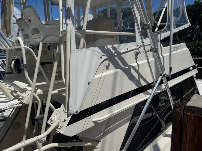 Slide: The Image of 1990 Viking 35 boat with white exterior and fishing equipment. - 9