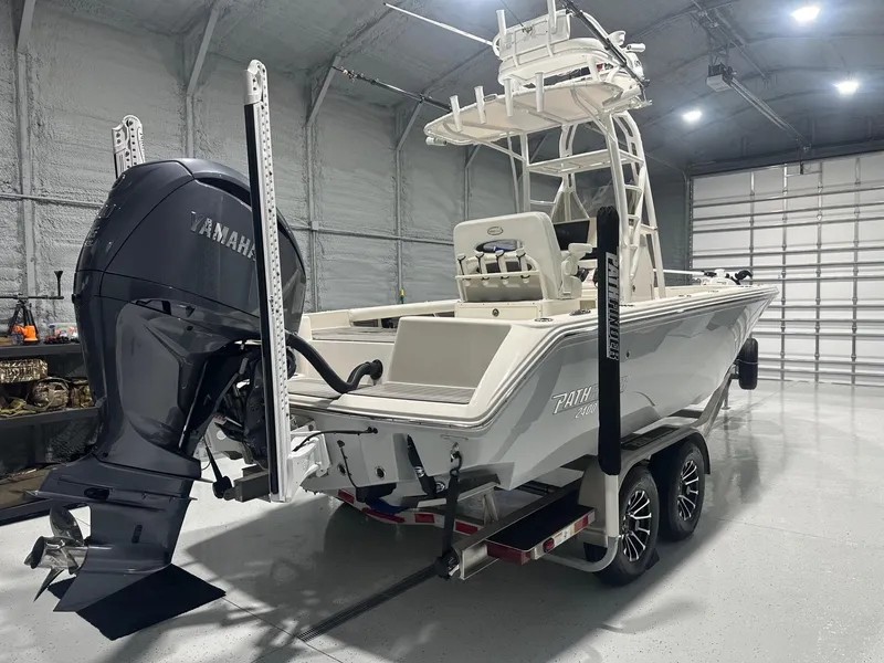Slide: The Image of 2024 Pathfinder 2400 TRS boat with Yamaha engine in a garage setting. - 3
