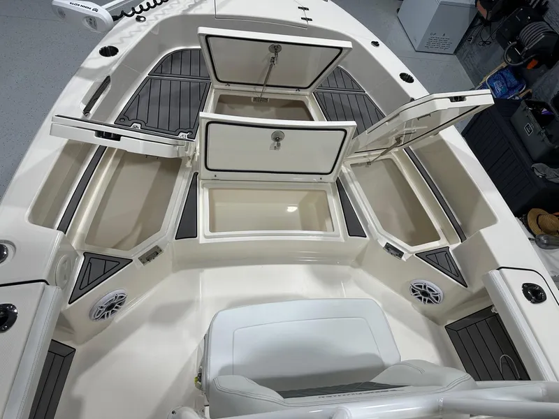 Slide: The Image of 2024 Pathfinder 2400 TRS boat interior with open storage compartments and seating. - 6