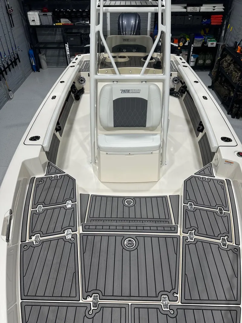 Slide: The Image of 2024 Pathfinder 2400 TRS boat interior with gray deck and seating. - 7