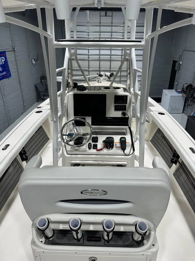 Slide: The Image of 2024 Pathfinder 2400 TRS boat interior with modern console and steering wheel. - 8
