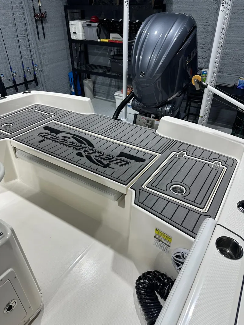 Slide: The Image of 2024 Pathfinder 2400 TRS boat interior with Yamaha outboard motor in a garage setting. - 9
