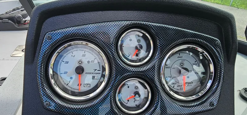 Slide: The Image of Dashboard of 2024 G3 Sportsman 2100 boat with carbon fiber finish and gauges. - 10