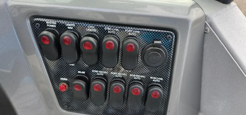 Slide: The Image of Control panel of 2024 G3 Sportsman 2100 boat with labeled switches and buttons. - 11