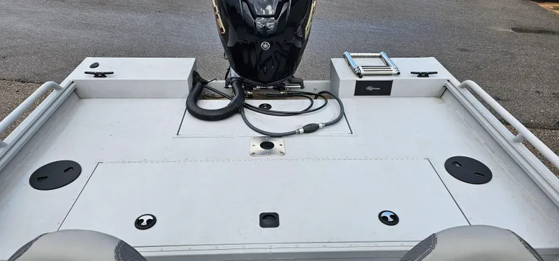 Slide: The Image of 2024 G3 Sportsman 2100 boat deck with motor and storage compartments. - 15