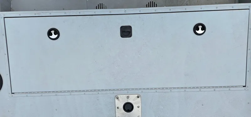 Slide: The Image of 2024 G3 Sportsman 2100 boat storage compartment with secure latches and durable design. - 16