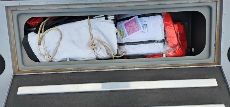 Slide: The Image of Storage compartment of 2024 G3 Sportsman 2100 boat with safety gear and ropes. - 17