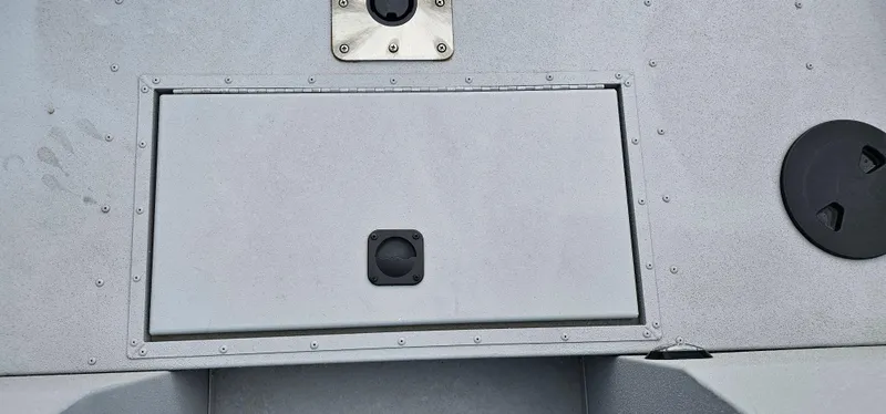 Slide: The Image of 2024 G3 Sportsman 2100 boat deck with storage compartment and latch. - 5