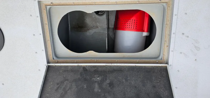 Slide: The Image of 2024 G3 Sportsman 2100 storage compartment with red container inside. - 6