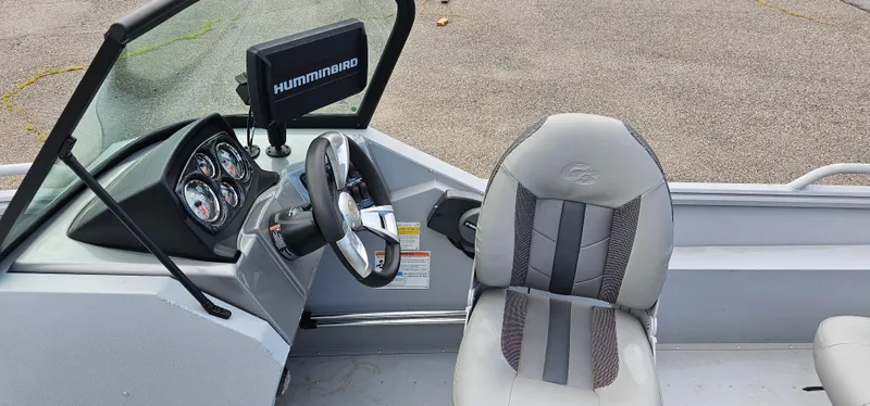 Slide: The Image of 2024 G3 Sportsman 2100 boat interior with steering wheel and Humminbird display. - 8