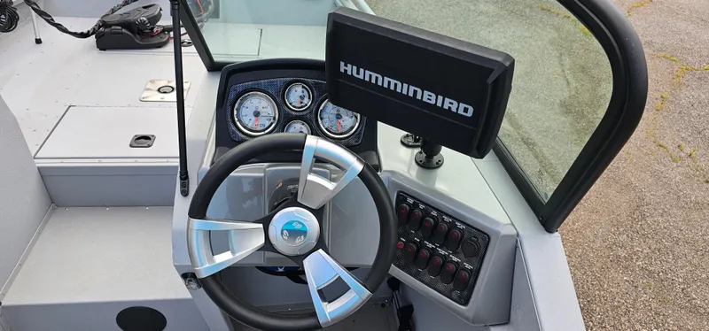 Slide: The Image of 2024 G3 Sportsman 2100 boat dashboard with steering wheel and Humminbird display. - 9
