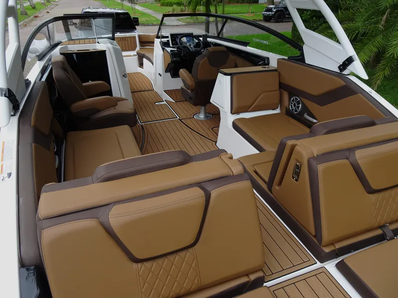 Slide: The Image of 2024 Yamaha Boats 252SE interior with luxurious brown seating and modern dashboard design. - 10