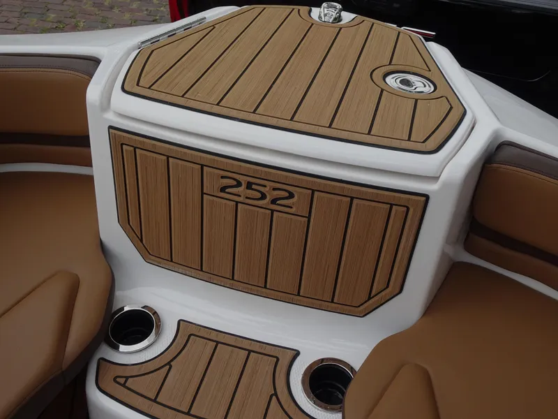Slide: The Image of 2024 Yamaha Boats 252SE interior with wood finish and cup holders. - 14