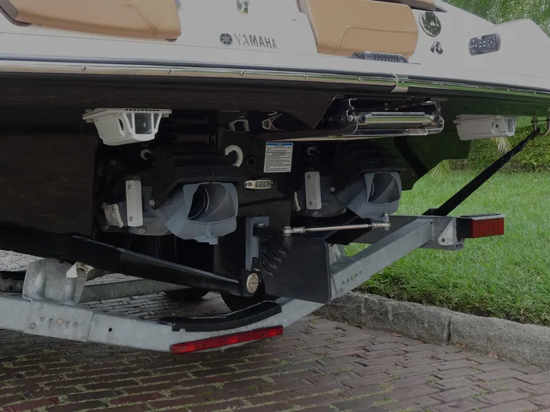 Slide: The Image of 2024 Yamaha Boats 252SE rear view showing dual jet propulsion system on trailer. - 26