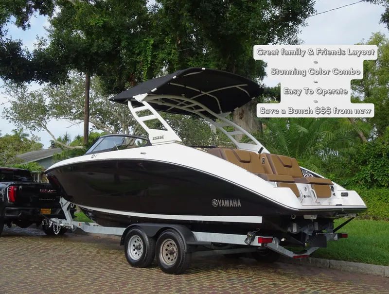 Slide: The Image of 2024 Yamaha Boats 252SE on trailer, sleek design, black and white color, outdoor setting. - 4