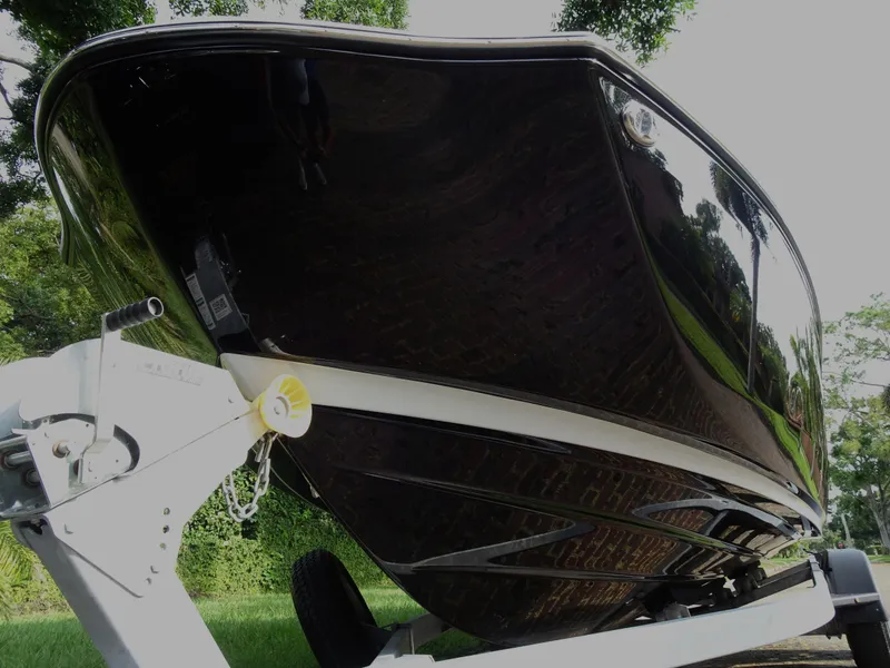 Slide: The Image of 2024 Yamaha Boats 252SE on trailer, sleek black hull, outdoor setting. - 6