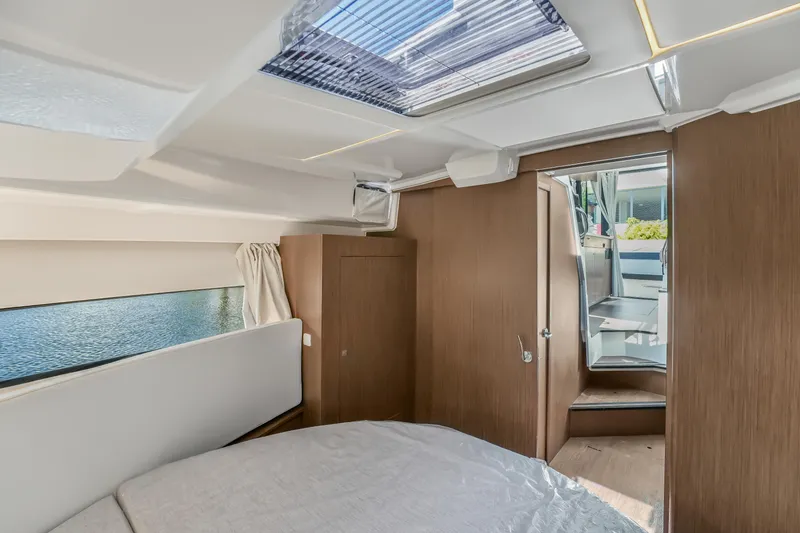Slide: The Image of 2024 Jeanneau NC1095 Fly cabin interior with skylight and wooden finish. - 10