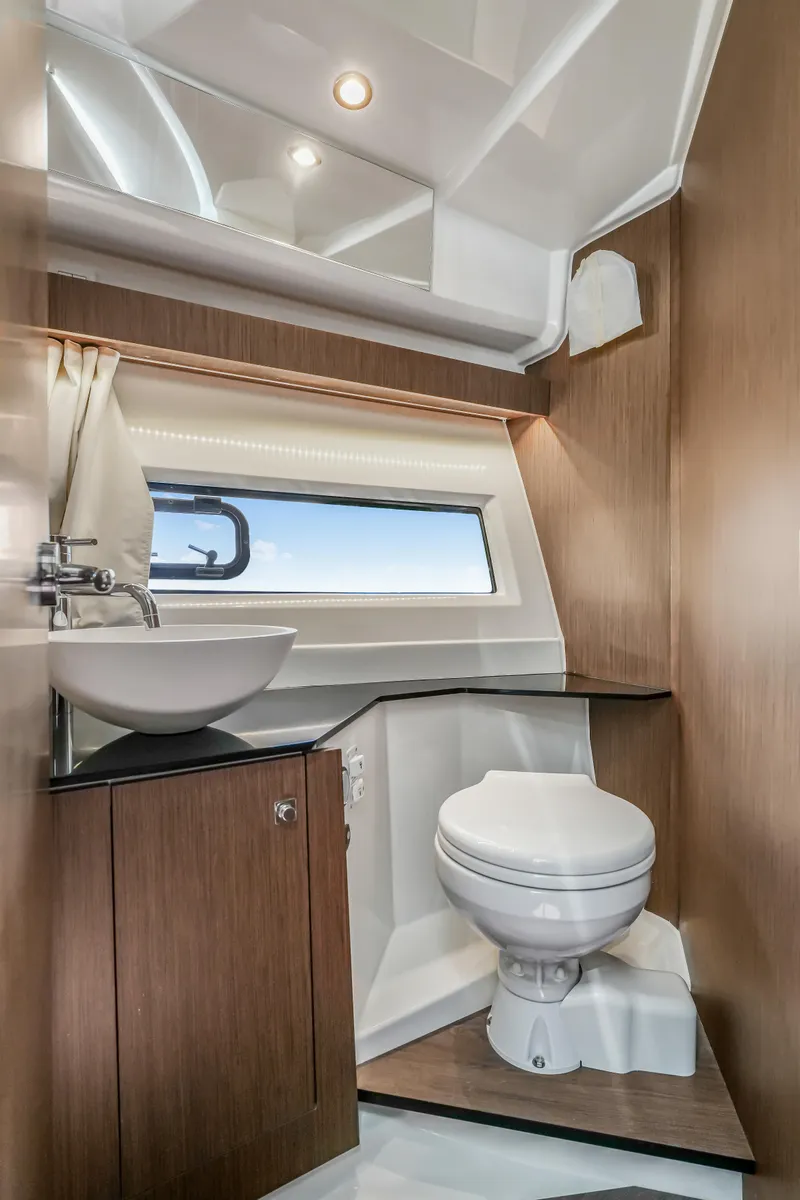 Slide: The Image of 2024 Jeanneau NC1095 Fly bathroom with modern fixtures and wood accents. - 11