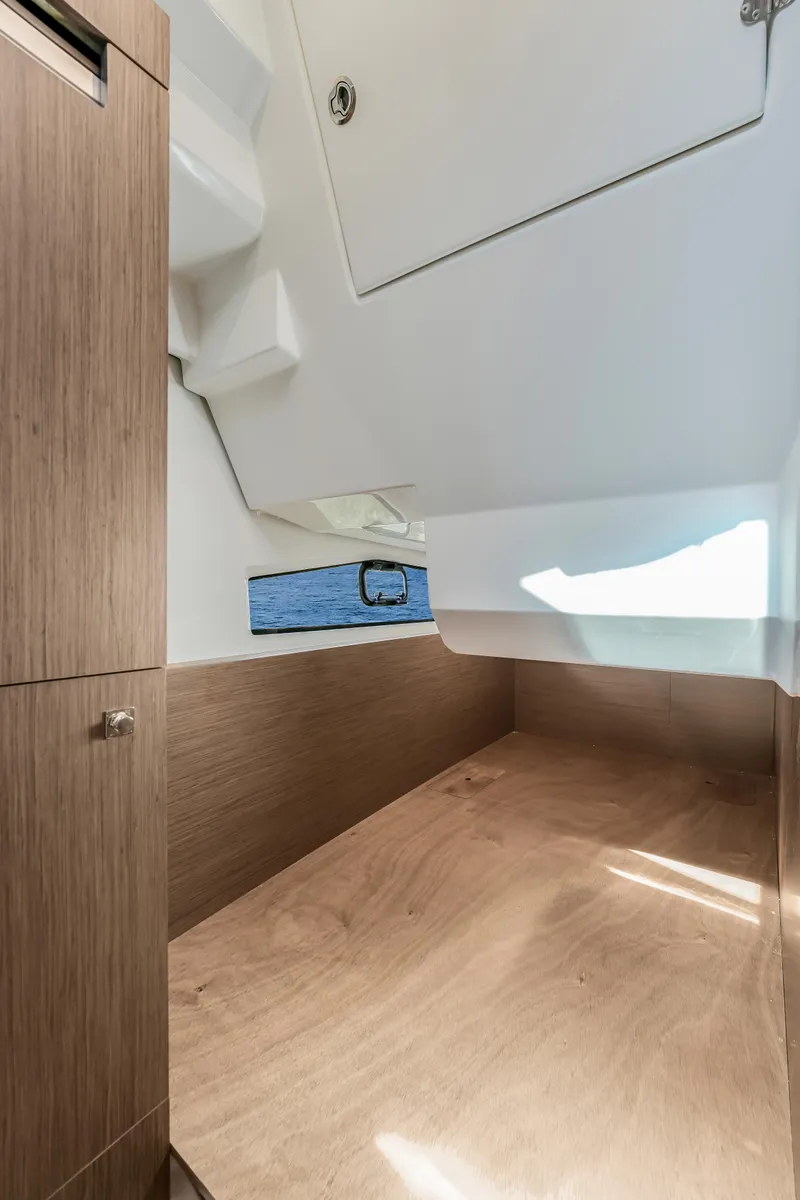 Slide: The Image of 2024 Jeanneau NC1095 Fly cabin interior with wood finish and window view. - 15