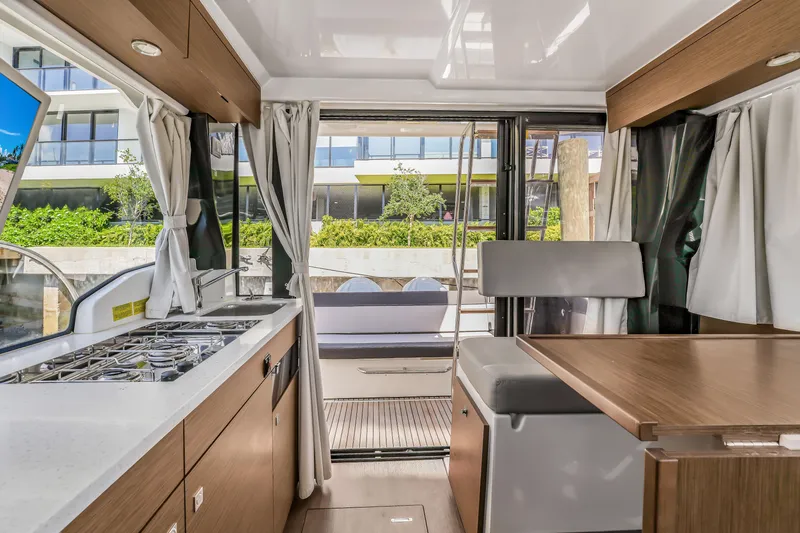 Slide: The Image of 2024 Jeanneau NC1095 Fly interior with modern kitchen and dining area. - 17